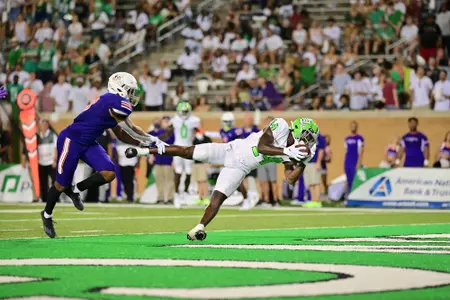Roderic Burns catches a touchdown pass against Northwestern State in the 2021 season opener at Apogee Stadium