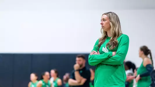 Assistant coach Emma Shaddix patrols the sideline in a spring match versus Midwestern State on April 25