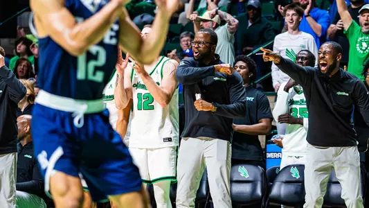 Coach Mo Ba celebrates after big basket versus Rice