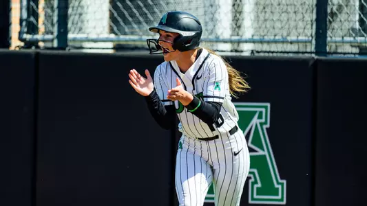 Addie Perry claps for teammates against Tulsa on March 15