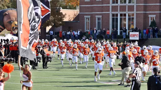 football team comes on football field