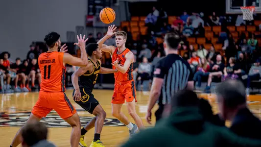 Michael Zanoni throwing the ball to Luis Hurtado Jr.