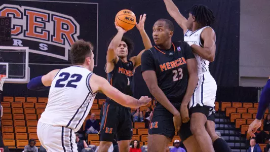 Kamar Robertson shooting while a defender tries to block it around a screen by James Glisson III