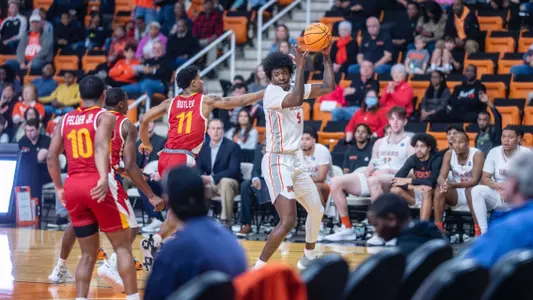 Jalyn McCreary trying to keep the ball away from opposing players after grabbing a rebound