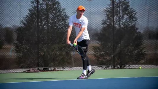 Marceau Foulihoux preparing to serve with the ball on his racket in front of his body