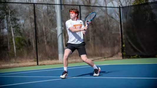 Samuel Barrow approaching the net to hit a backhand shot