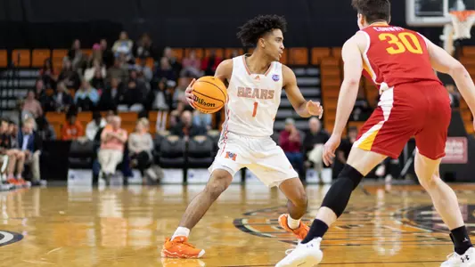 Kamar Robertson cutting around a defender with the ball in his right hand