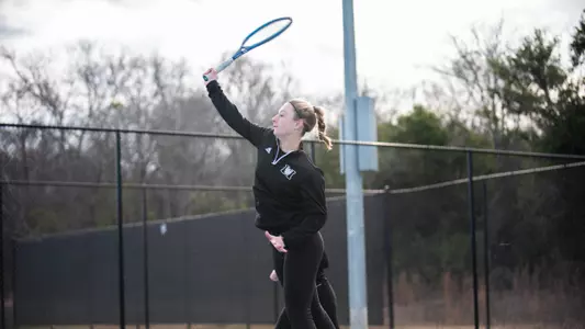 Mary Weston Courville jumping to hit an overhead shot