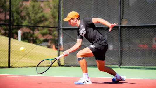 Marceau Foulihoux leaning down to hit a shot