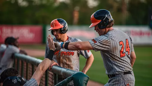 Eric Toth giving a player a high five in the dugout