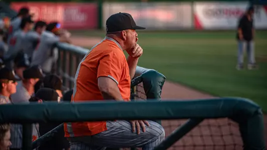 Coach Gibson looking at the field from the dugout