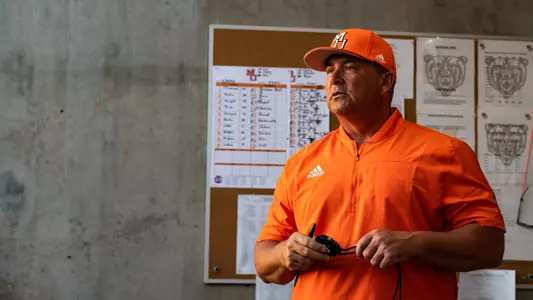 Craig Gibson looking onto the field from the dugout
