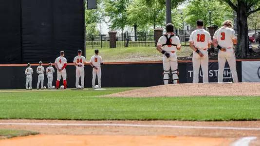 The starters lined up in the outfield for the national anthem