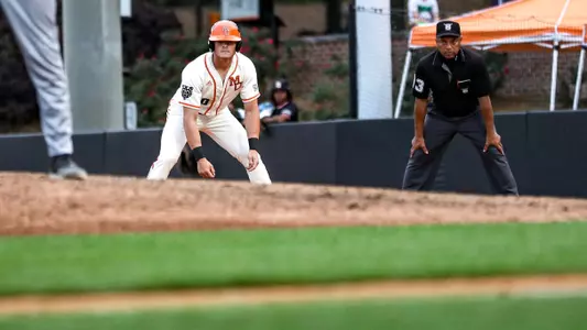 Conner Todaro standing beside first base waiting to run to second base