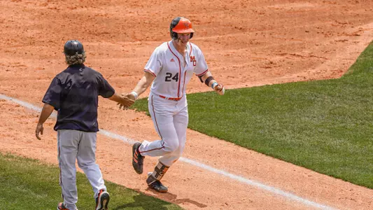 Eric Toth running past third base high fiving Willie Stewart