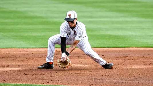 Bradley Frye reaching down to scoop up a ground ball