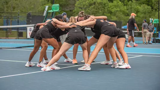 Women's tennis team in a huddle