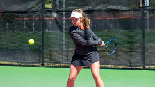 Mary Weston Courville about to hit a backhand shot