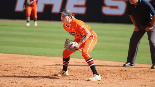 Softball player bending down