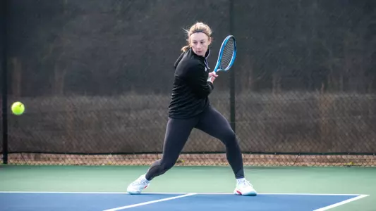 Mary Weston Courville about to hit a backhand shot