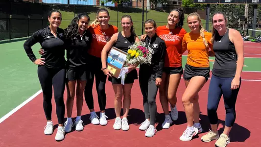 Mary Weston Courville with her teammates while holding her Senior Day plaque