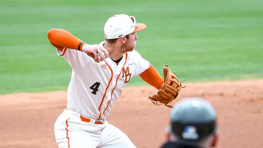 Carter Geier throwing a ball from third base