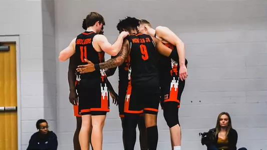 MBB team huddle at Queens