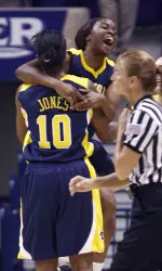 Dayeesha Hollins, top left, hugs Ashley Jones after beating Xavier 72-71. (AP Photo/David Kohl)