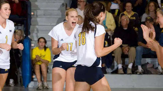 Lexi Zimmerman (17) celebrates a kill by Juliana Paz (18)