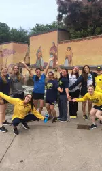 The team poses by a fountain during their Downtown walk.