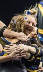 Nicole Artz celebrates her 10.0 with her teammates