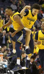 Zak Irvin (left) and D.J. Wilson (5) celebrate in the first half