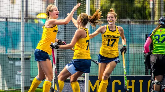Esther de Leijer (left) celebrates with Sina Lampe (7) and Morgan Dever (17)
