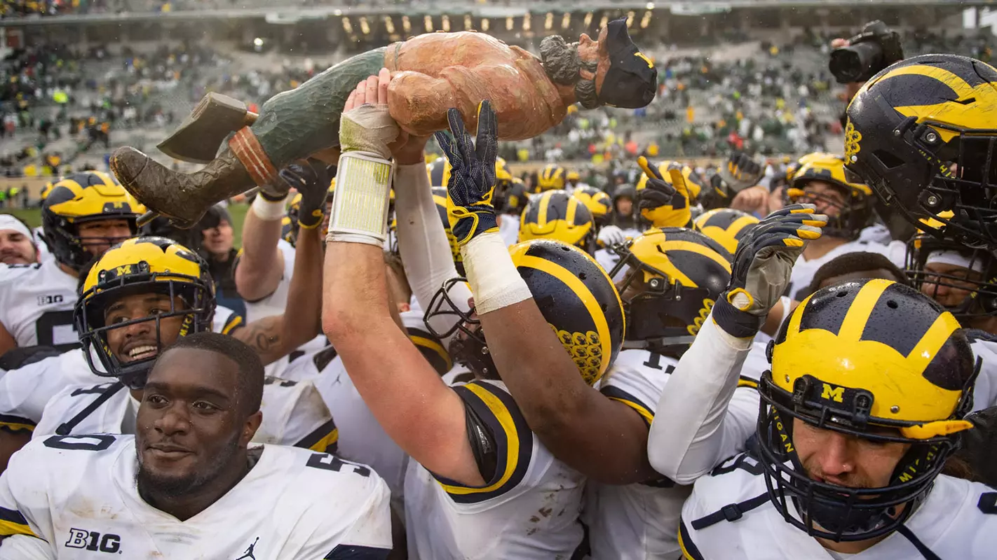 Football Players with Paul Bunyan Trophy