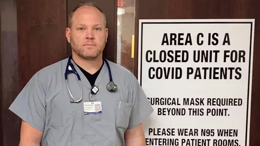 Chris Hutchinson in front of COVID-19 Area Door