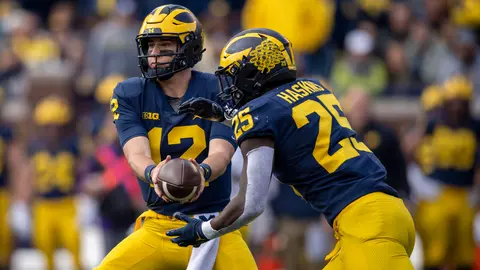 Cade McNamara (left), Hassan Haskins