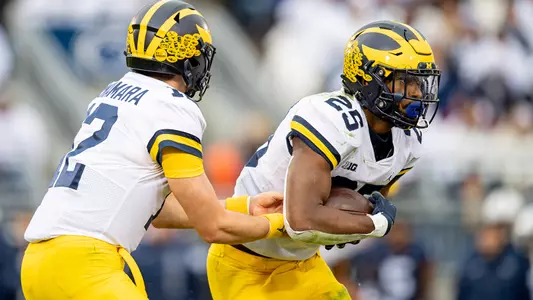 Cade McNamara (left), Hassan Haskins