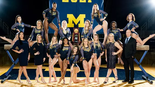 Women's Gymnastics Team Photo With NCAA Trophy