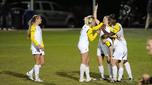 Clare Stachel (arm raised) celebrates her game-tying goal