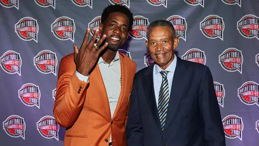 Chris Webber (left) with his father Mayce Webber Jr. (Jon Lopez/Naismith Memorial Basketball Hall of Fame)