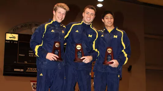 Ryan McCarthy (center), Ian Makowske (left) and Mel Anton Santander finished 1-2-3 on high bar