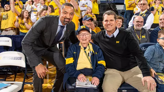 Al Glick (center) with Juwan Howard (left) and Jim Harbaugh