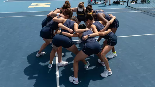 Women's tennis team huddle outside generic