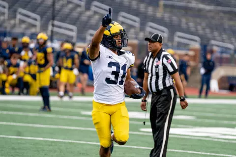 Jalen Perry celebrates after returning an interception for a touchdown