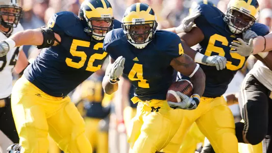 Brandon Minor (4) with Stephen Schilling (52) and Patrick Omameh (65)