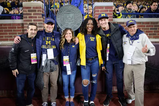From left: Justin Toman (gymnastics), Ryan Bertin (wrestling), April Fronzoni Bertin (field hockey), Tiffany Ofili Porter (track & field), Peter Vanderkaay (swimming & diving) and Ron Warhurst (cross country and track & field head coach)