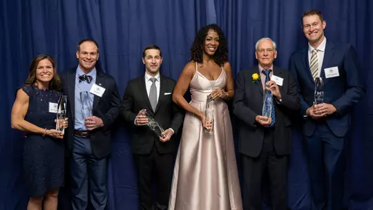 From left: April Fronzoni Bertin (field hockey), Ryan Bertin (wrestling), Justin Toman (gymnastics), Tiffany Ofili Porter (track & field), Ron Warhurst (cross country and track & field head coach) and Peter Vanderkaay (swimming & diving)