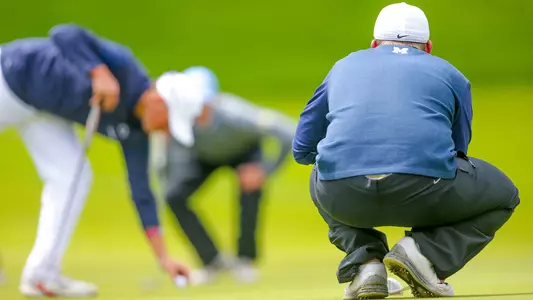 Men's Golf Lining Up a Putt
