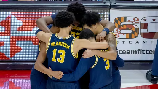 Men's Basketball Team Huddle
