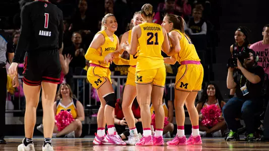 Women's basketball team huddle pink game